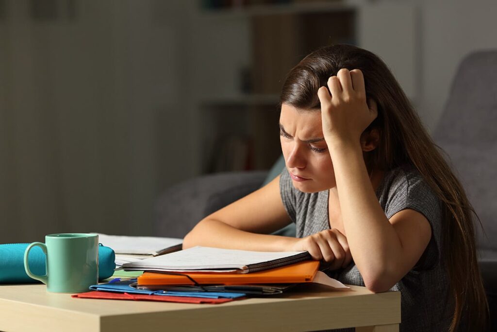 student looking at papers coping with anxiety