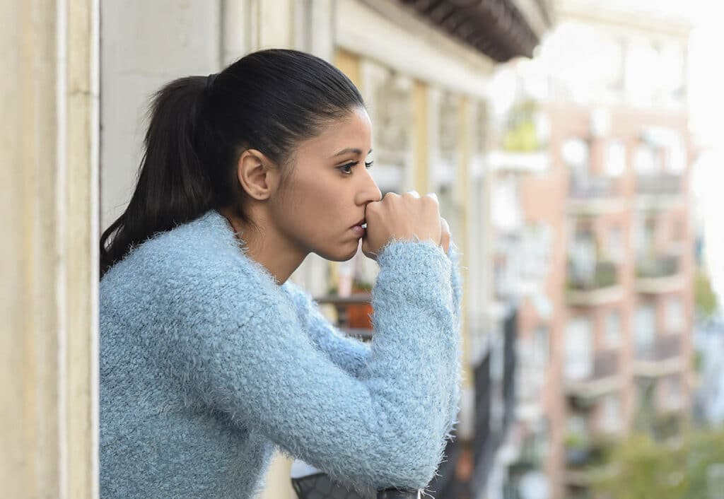 woman on a veranda thinking