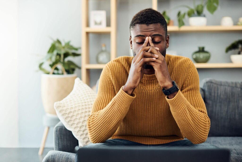 young man looking stressed out at home