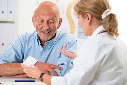 doctor explaining to older patient medication assisted treatment services