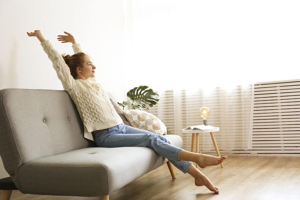 Woman stretching on couch Maintaining Mental Wellness