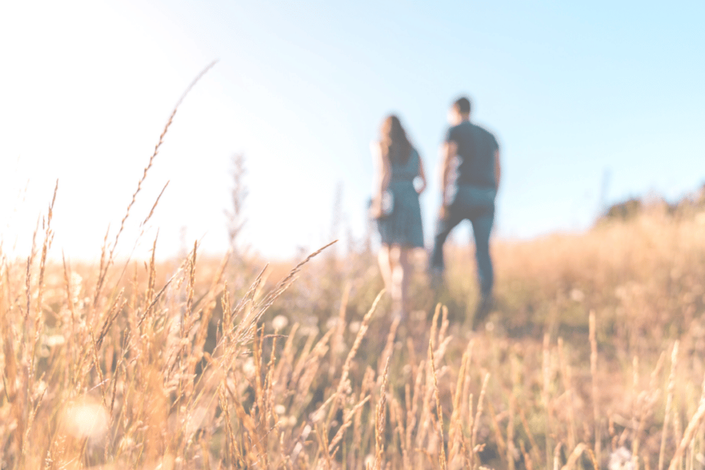 couple walking on a dry grass land