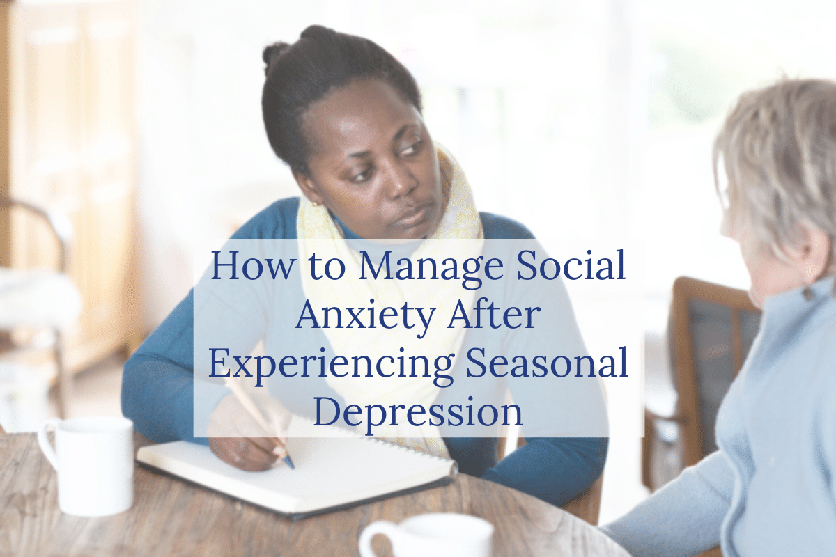 A woman writes in a notebook while attentively listening to another woman. Overlaid text reads, How to Manage Social Anxiety After Experiencing Seasonal Depression.